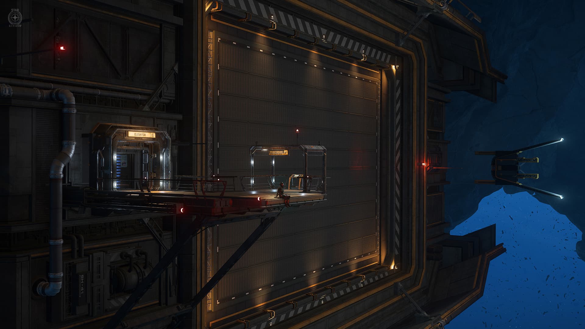 A pilot waiting on a service platform beside a ship in a lit hangar